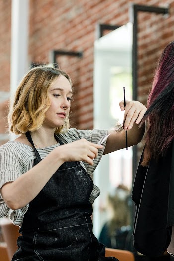 Hairstylist trimming hair of the customer in… | Free stock photo | High Resolution image