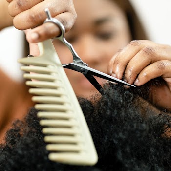 Hairstylist trimming the customer's hair at a… | Free stock photo | High Resolution image