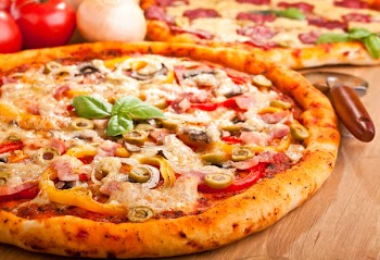 ham, mushroom and vegetable pizza and salami pizza at the back