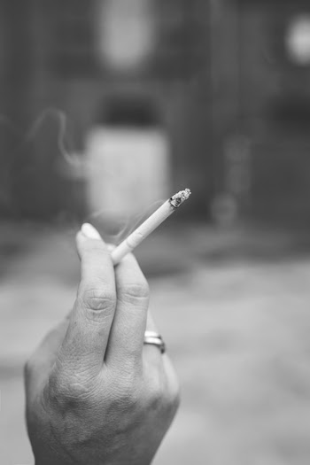 Hand holding a cigarette