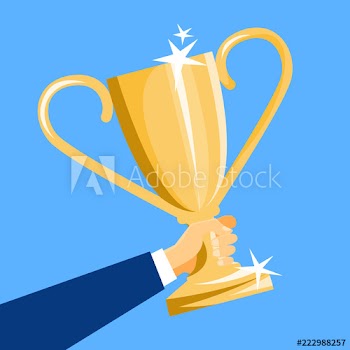 Hand holding a golden shining trophy cup