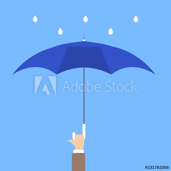 Hand holding blue umbrella as metaphor of insurance