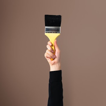 Hand holding brush for wall painting | Free stock photo | High Resolution image