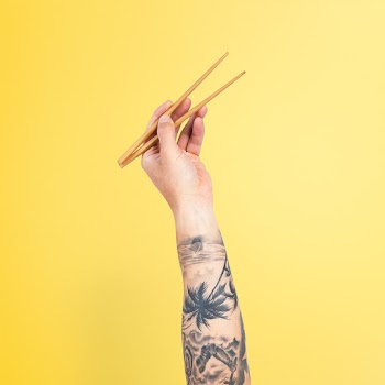Hand holding chopsticks for food concept | Free stock photo | High Resolution image