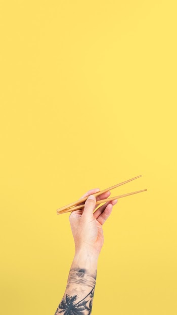 Hand holding chopsticks for food concept | Free stock photo | High Resolution image
