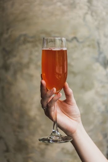 Hand Holding Cocktail In Tall Glass