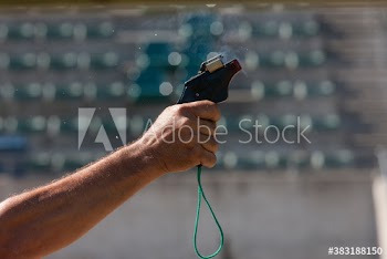 Hand holding track and field starting gun