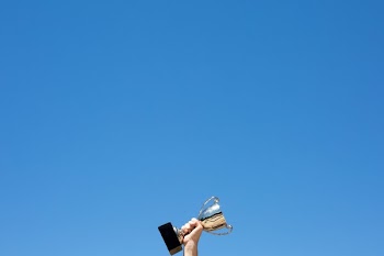 Hand Holding Trophy