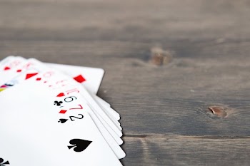 Hand Of Cards On Wood