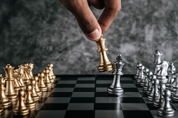 Hand of man playing chess for business planning and comparison of metaphor, selective focus Free Photo