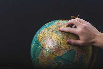 Hand Points On Globe