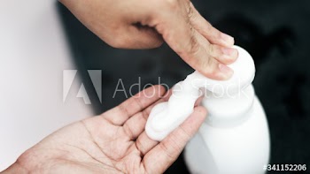 Hand pumping foam soap from a bottle