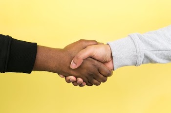 Hand Shake On Yellow