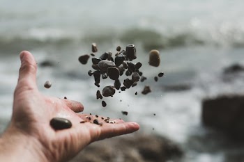 Hand Tossing Pebbles
