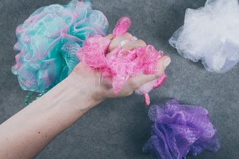Hand Using Body Wash Sponge
