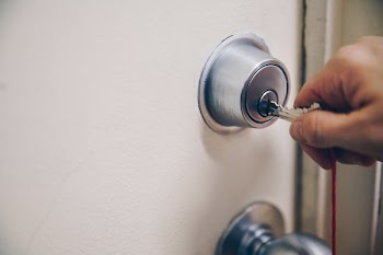 Hand Using Key In Door
