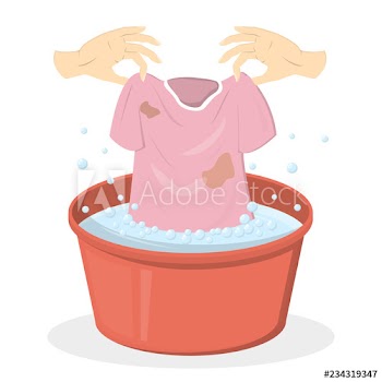 Hand washing clothes in a red basin