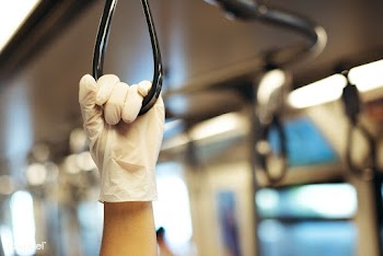 Hand wearing a latex glove while holding a train handrail  to prevent .. | Free  photo - 2295836