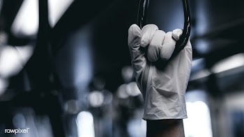 Hand wearing a latex glove while holding a train handrail  to prevent .. | Free  photo - 2296761