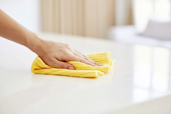Hand Wiping Tabletop with Microfiber Cloth