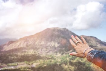 hand with accessory with mountain background
