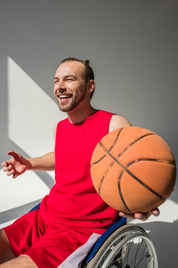 Handicapped sportsman holding basketball