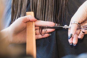 Hands Cutting Long Brown Hair