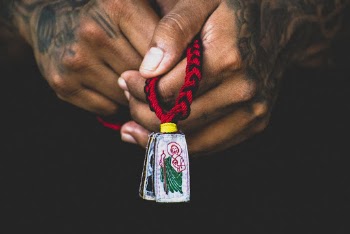 Hands Holding Silver-colored and Red Pendant Necklace