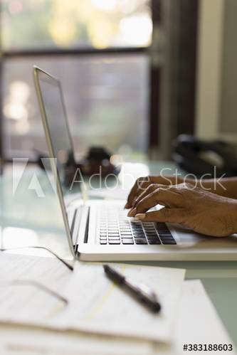 Hands of businesswoman typing on laptop