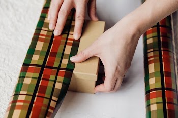 Hands Wrapping Presents With Paper