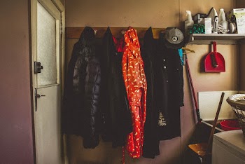Hanged Black and Orange Coats Inside Room