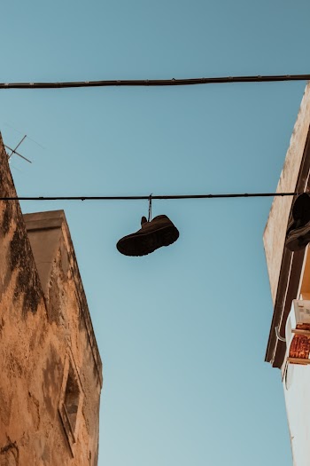 Hanged Brown Shoe on Black Wire