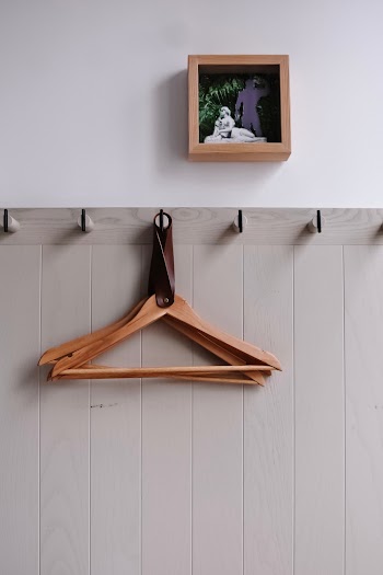 Hanged Brown Wooden Hangers Near Square Brown Wooden Photo Frame