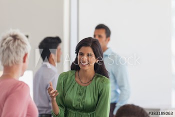 Happy businesswomen talking in meeting