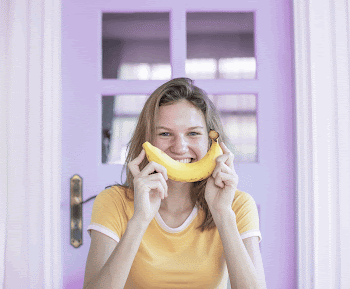 Happy Caucasian woman with banana | Free Photo - rawpixel