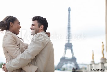Happy couple hugging in front of Eiffel Tower, Paris, France