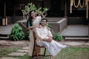 Happy Couple in Traditional Costumes Posing in Garden