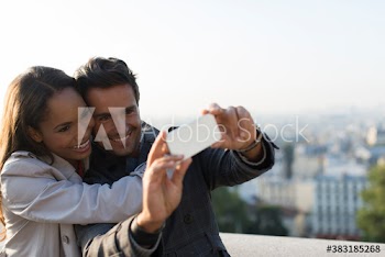 Happy couple taking selfie with camera phone