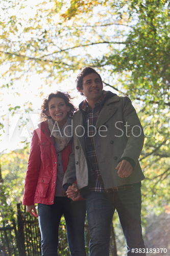 Happy couple walking in park