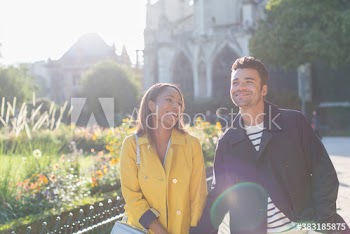 Happy couple walking in sunny park, Paris, France