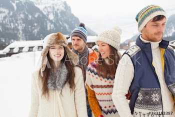 Happy couples friends walking in snow