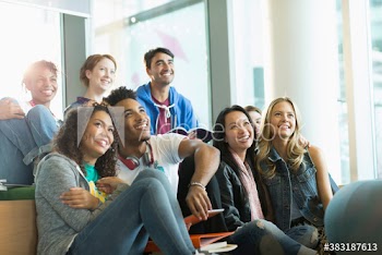 Happy diverse young college students in student lounge