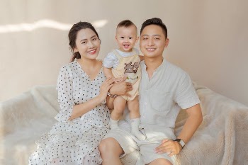 Happy ethnic family with kid on sofa