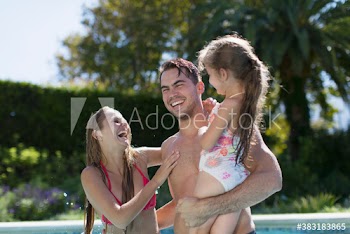 Happy family in swimming pool