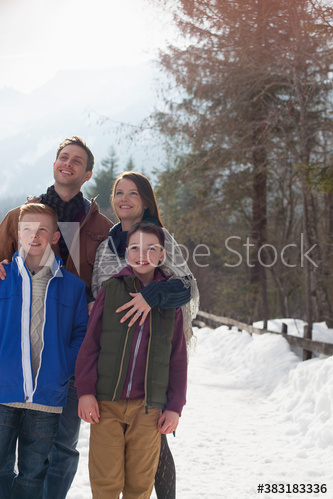 Happy family on snowy footpath