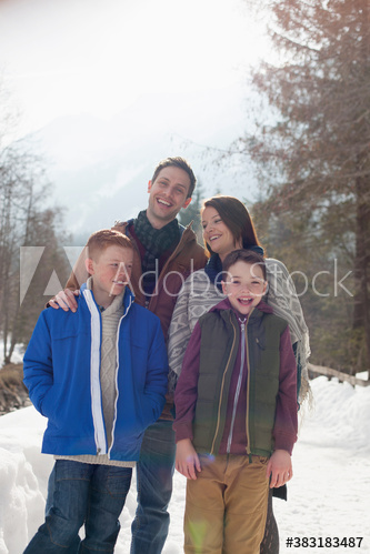 Happy family on snowy footpath