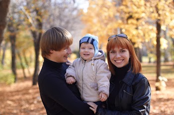 Happy family on walk in park in the autumn