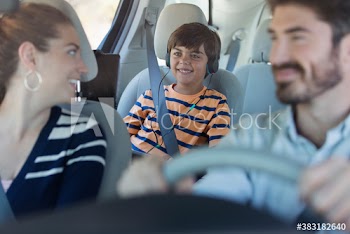 Happy family riding in car