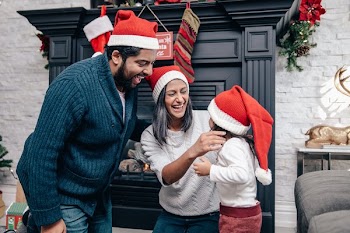 Happy Family Wearing Santa Hats