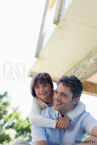 Happy father and daughter hugging on patio